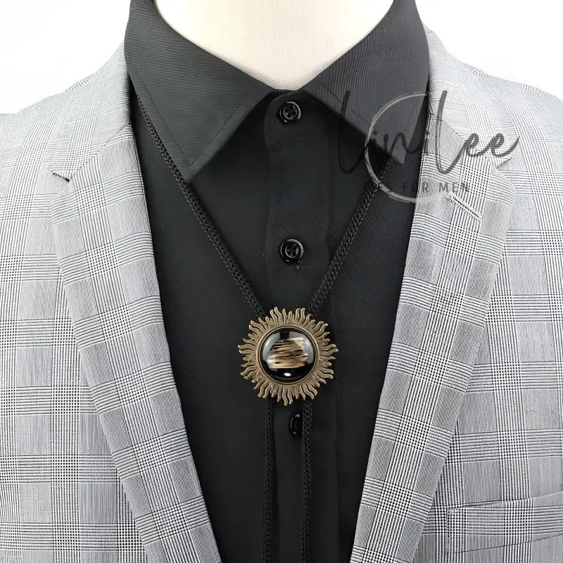 Bolo tie with sunburst pendant.