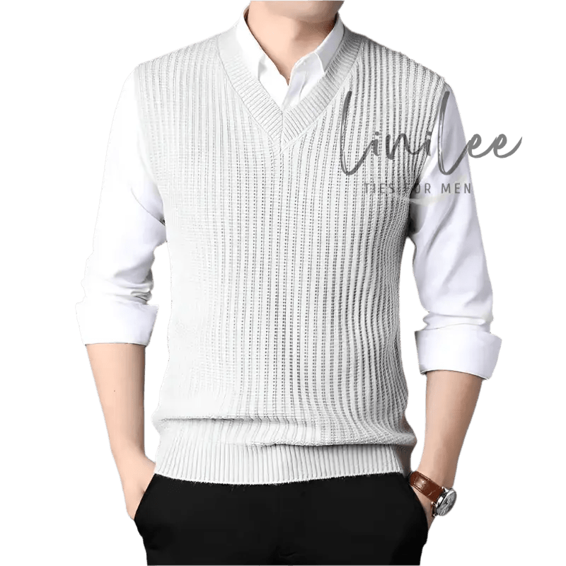 Man wearing a white shirt and a gray sweater vest.