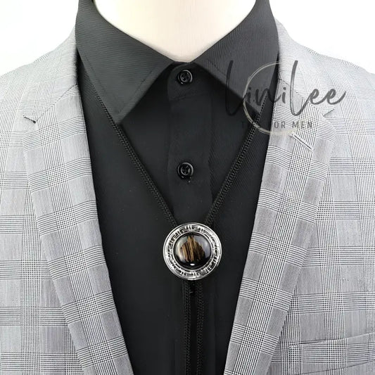 Black bolo tie with silver circular pendant.