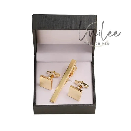 Gold tie clip and cufflink set.