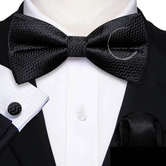 Black patterned bow tie with matching accessories.