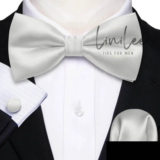 White satin bow tie with matching cufflinks and pocket square.