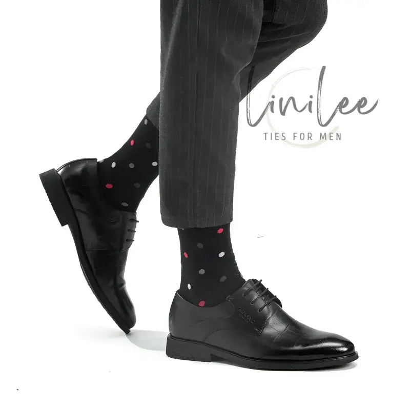 Black leather dress shoes with polka dot socks.