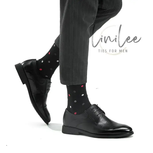Black leather dress shoes with polka dot socks.