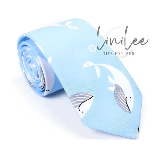 Rolled light blue tie with whale pattern.