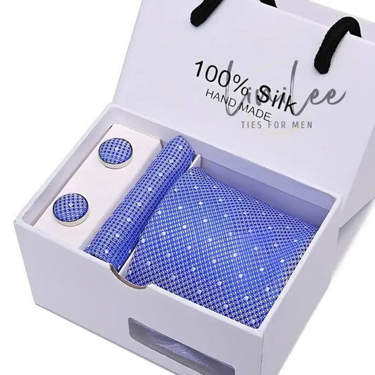 Blue tie and cufflink set in a white gift box.