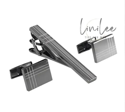 Gunmetal tie clip and cufflinks set.